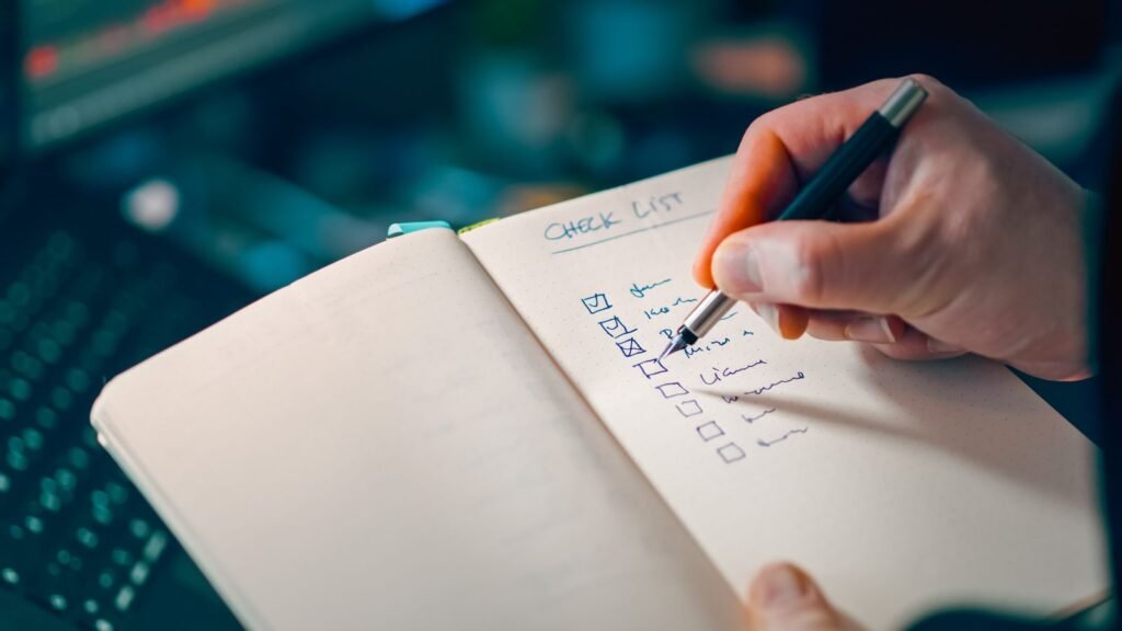 Online exploitation evidence: hand writing a checklist in an open notebook on a desk