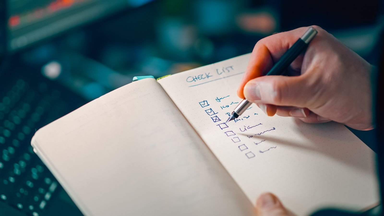Online exploitation evidence: hand writing a checklist in an open notebook on a desk