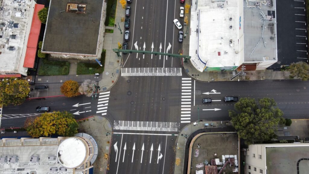 Car accident liability: aerial view of cars moving through a busy city intersection
