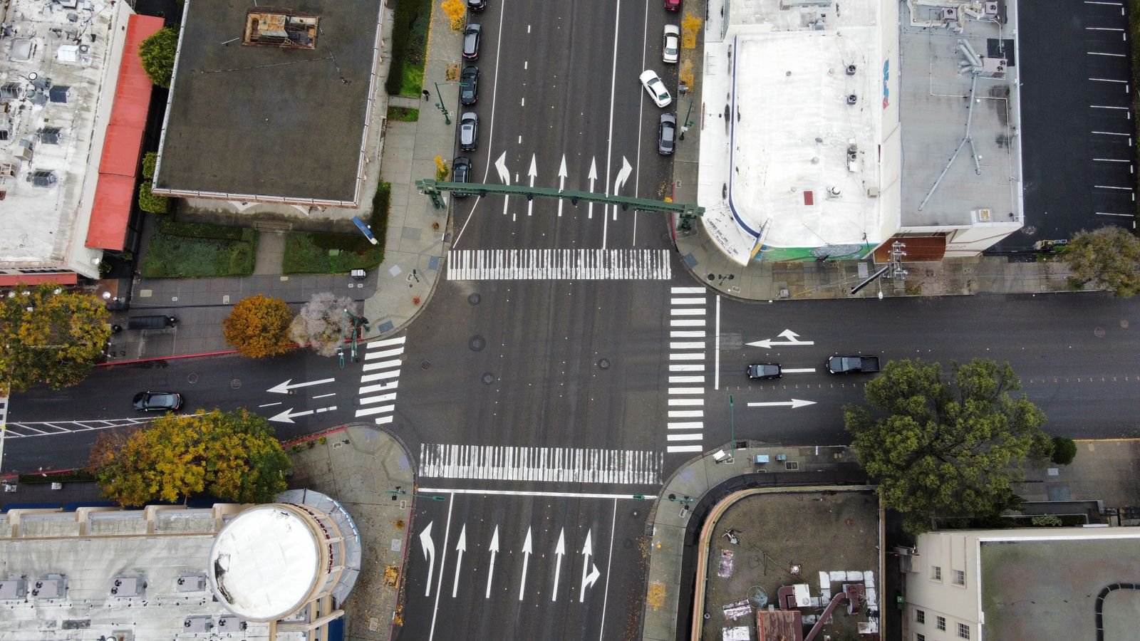 Car accident liability: aerial view of cars moving through a busy city intersection