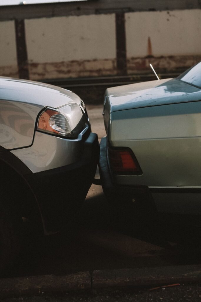 Car accident liability: close-up of two cars after a minor rear-end collision