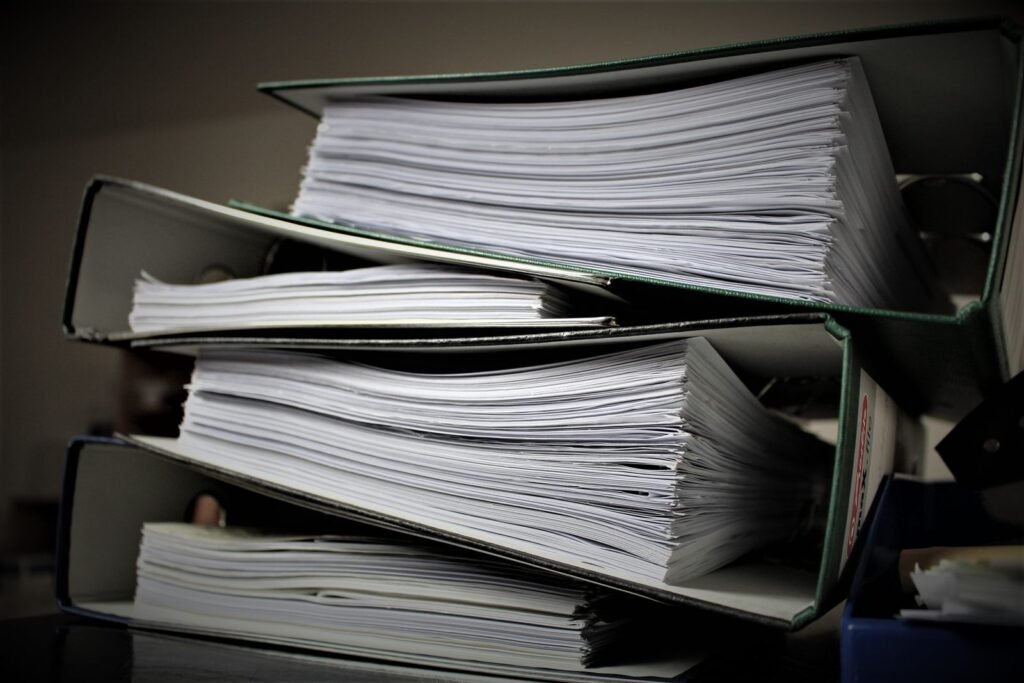 Stack of binders filled with documents, showing how to organize records and bills