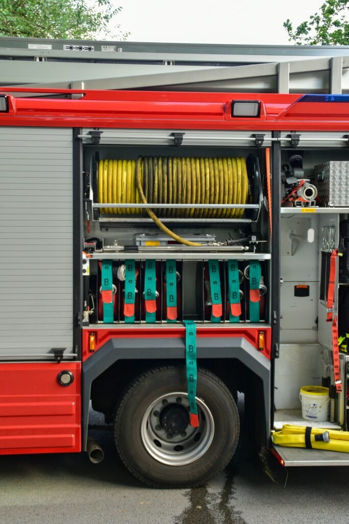 Fire truck equipment compartment with a yellow hose and tools