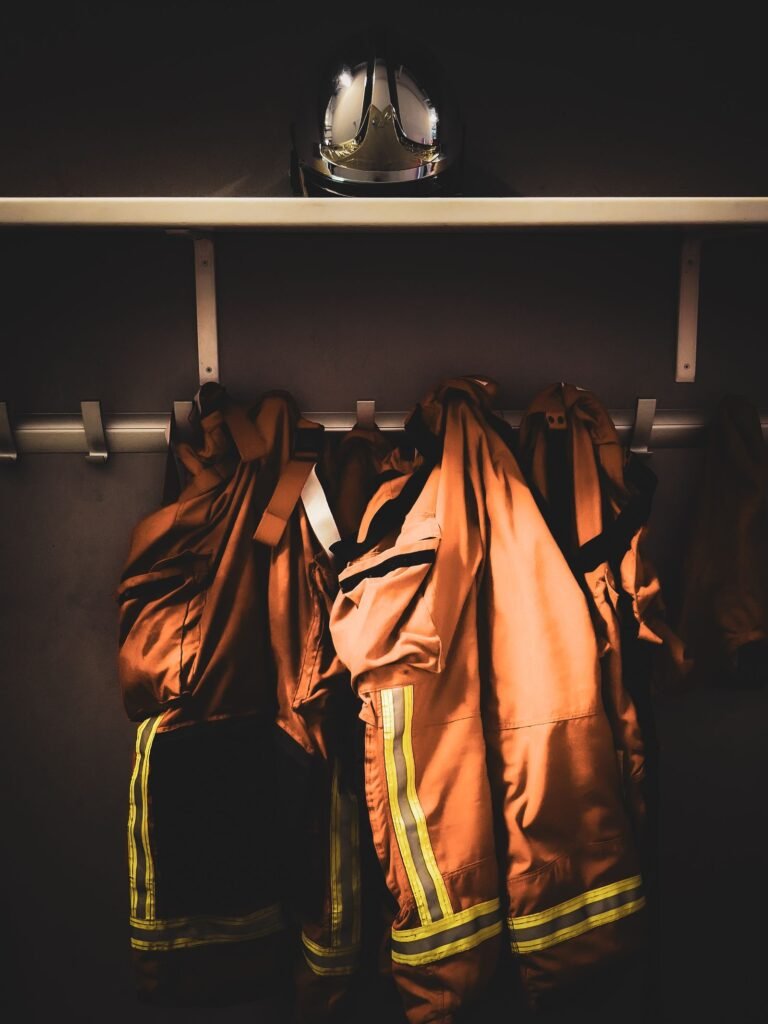 Firefighter turnout gear hanging in a station locker room, the kind of exposure the AFFF MDL reviews