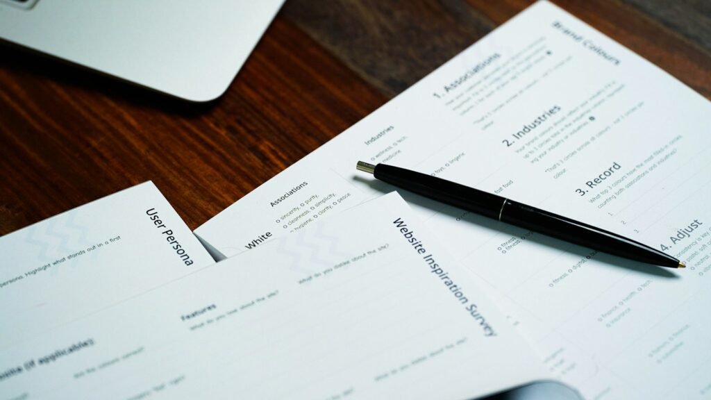 Pen resting on a pile of papers, like the documents that come with an Edison Eaton Fire offer