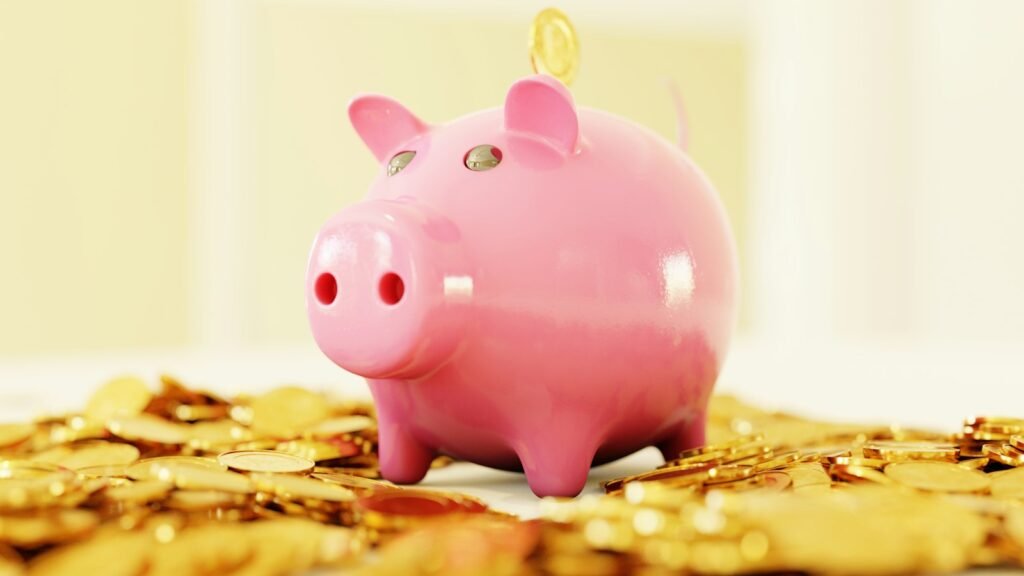 Pink piggy bank surrounded by gold coins, representing in-game spending limits for kids