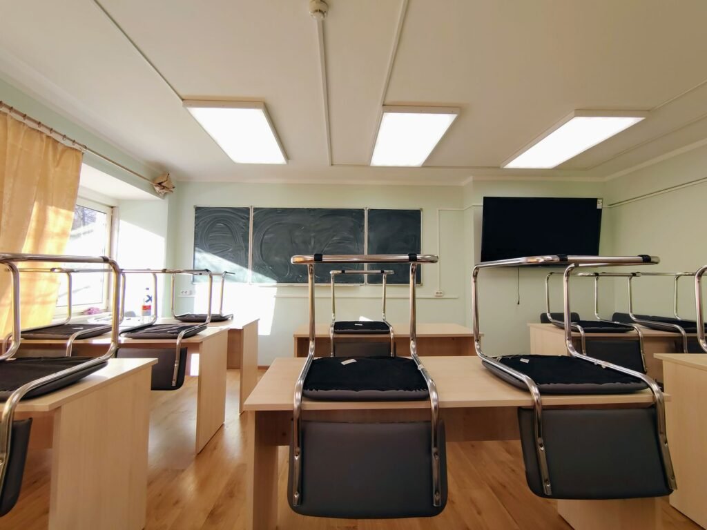 Empty classroom with chairs stacked on desks, illustrating school abuse claims under California SB 577
