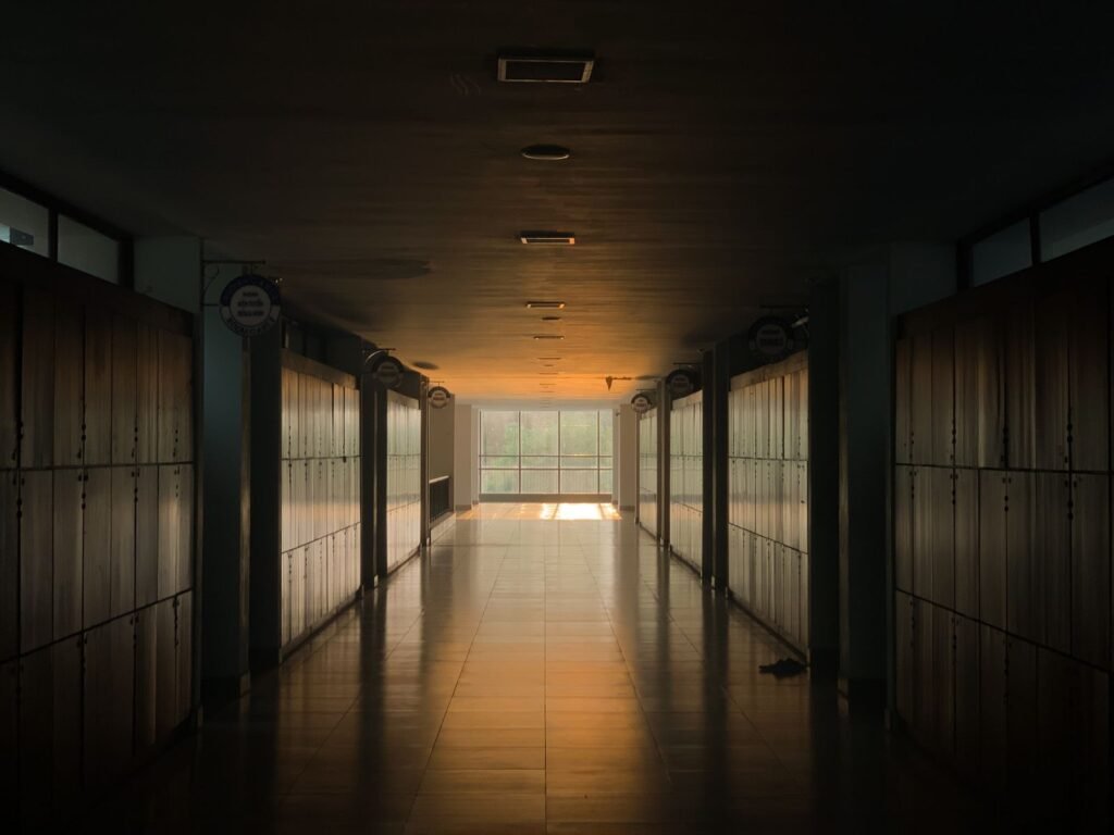 Sunlit empty school hallway lined with lockers