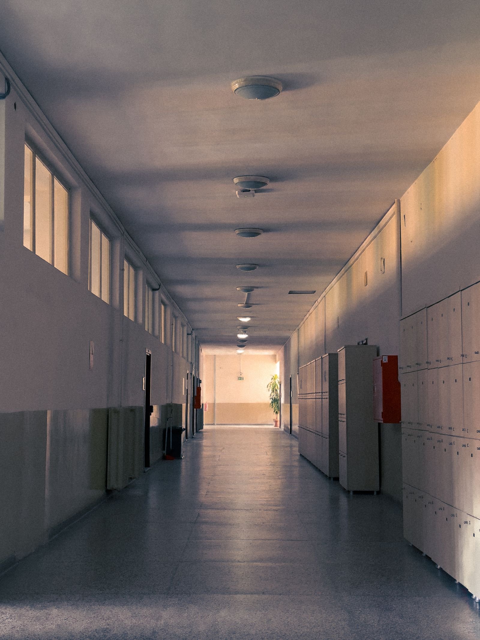 California sb 577: empty school hallway with rows of lockers