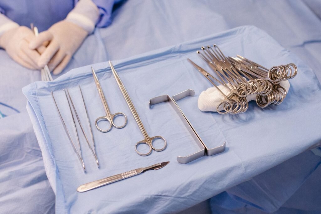 Surgical instruments arranged on a blue sterile drape in an operating room
