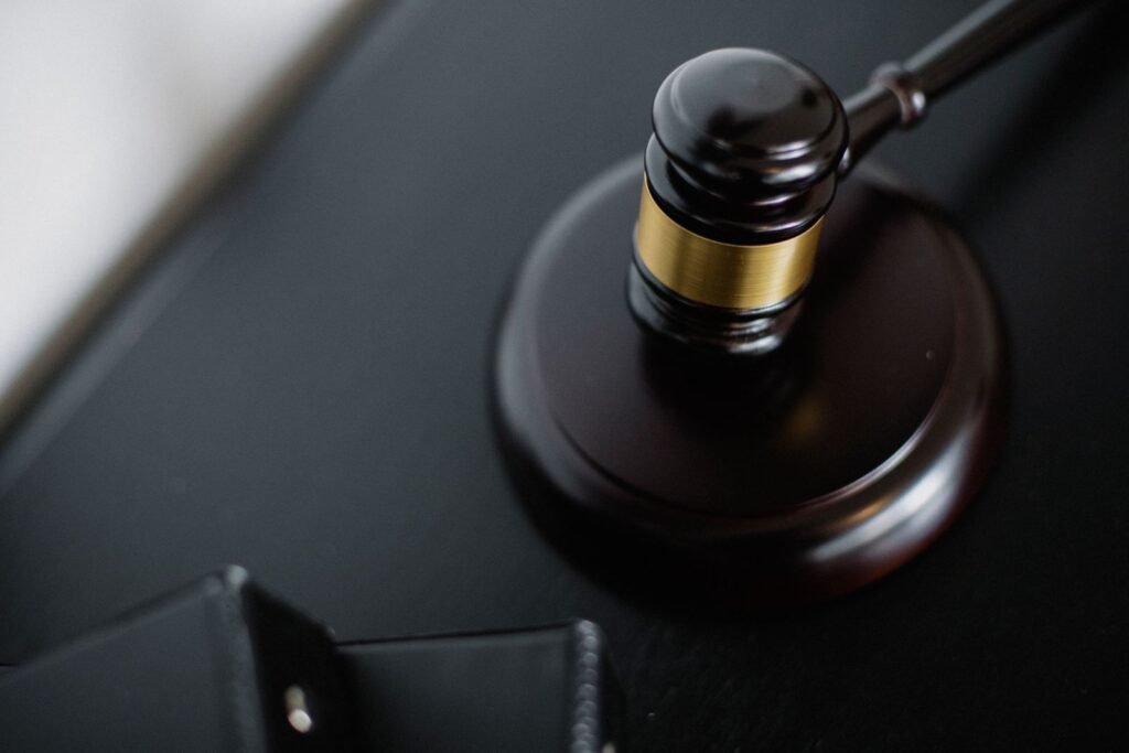 Wooden judge's gavel on a dark desk
