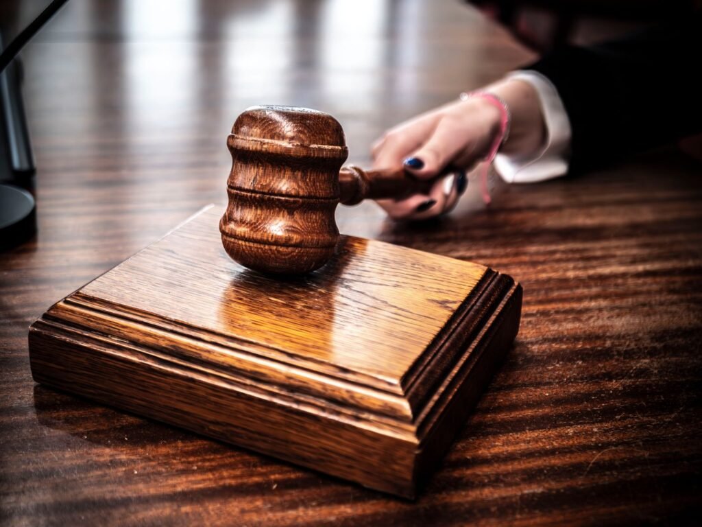 Wooden gavel resting on a judge's desk in a courtroom