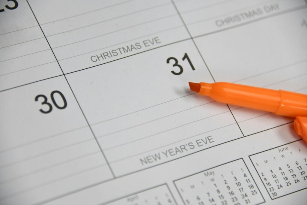 Marker resting on a paper calendar, used to track injection dates