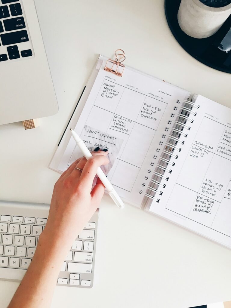 Notepad, pen and office supplies laid out for writing questions before a call