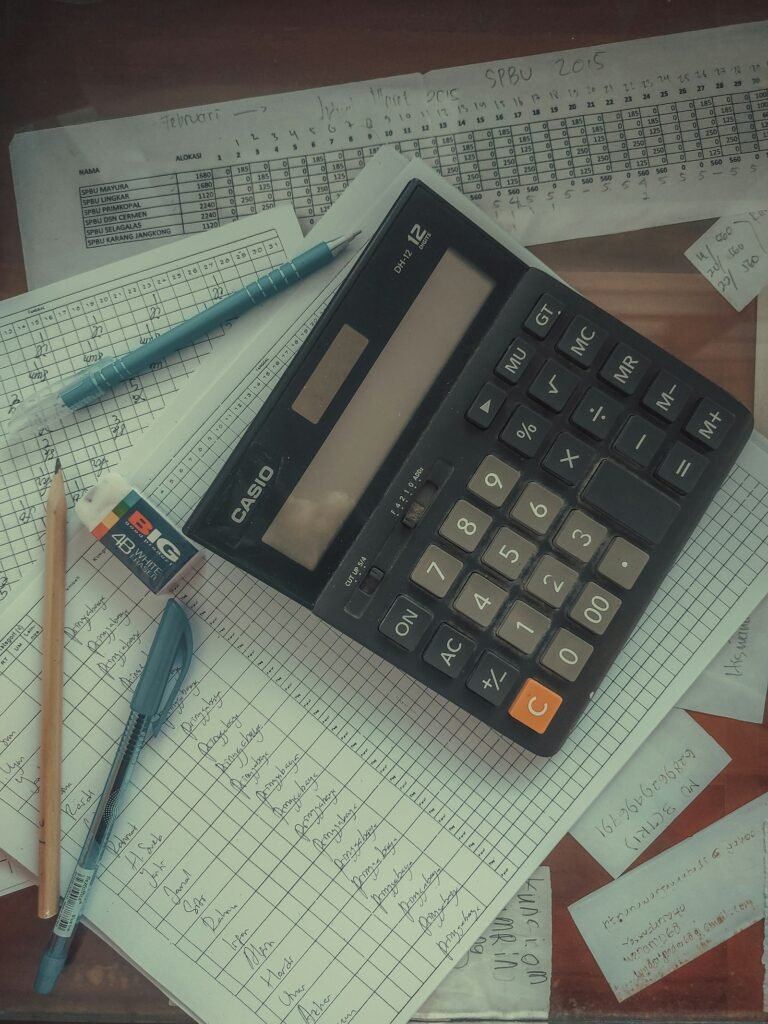 Final expense claim denied: calculator resting on a pile of papers on a desk, representing a final expense claim review