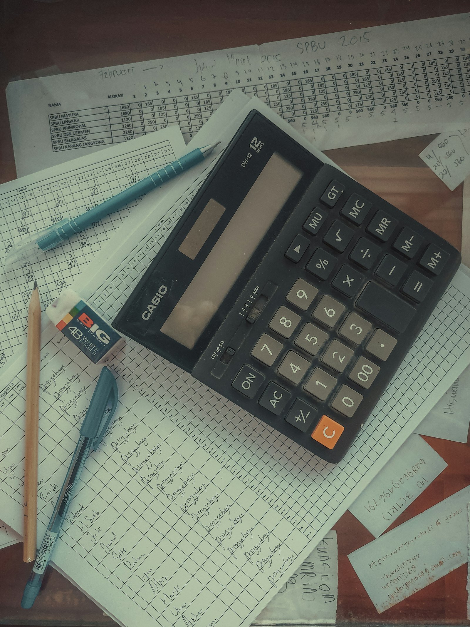 Final expense claim denied: calculator resting on a pile of papers on a desk, representing a final expense claim review