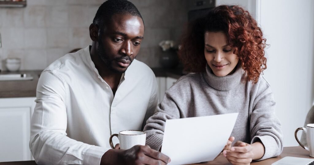 Couple reviewing a final expense life insurance claim at the kitchen table
