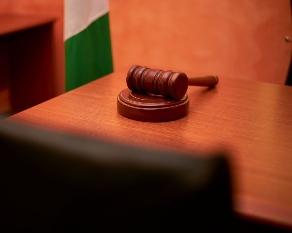 Judge's gavel resting on a wooden courtroom desk