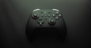 Video game controller resting in a dark room, illustrating gaming disorder symptoms