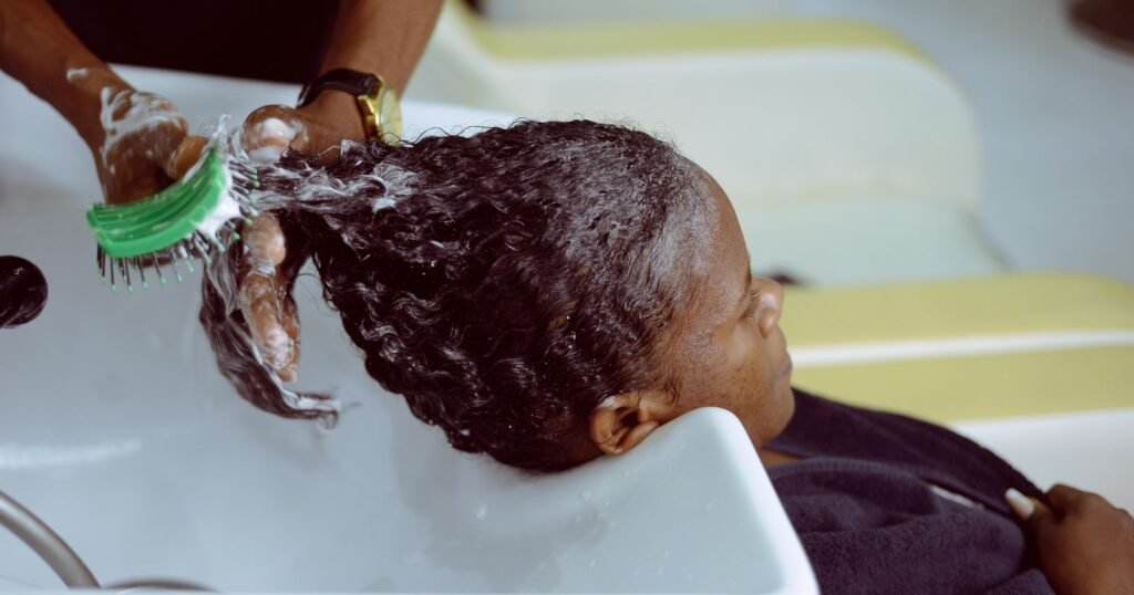 Woman receiving a chemical hair treatment at a salon