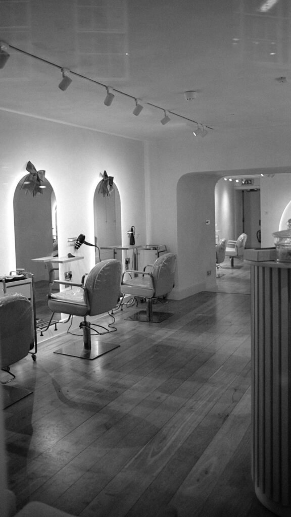 Bright hair salon with styling chairs and mirrors, where many women's hair relaxer uterine cancer questions begin
