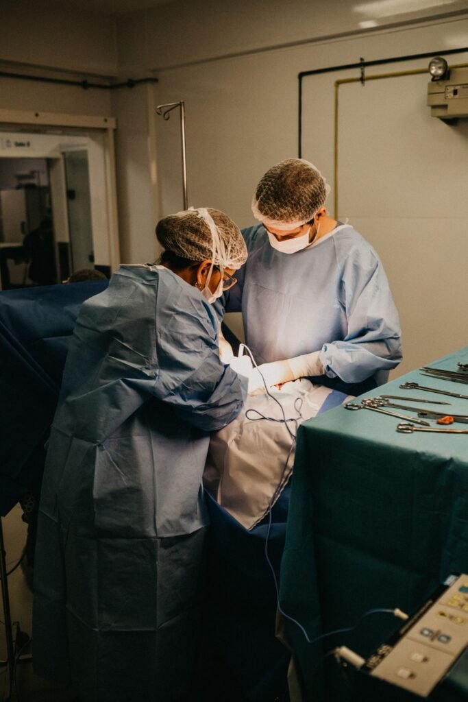 Hernia mesh complications: surgeons performing an operation in a hospital operating room
