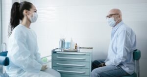 Man discussing hernia mesh lawsuit eligibility and surgery history with a doctor