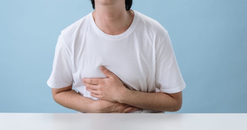 Man holding his abdomen in pain after hernia mesh repair