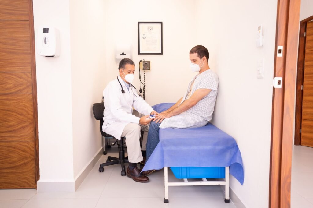 Doctor checking a patient during a follow-up visit after hernia mesh surgery