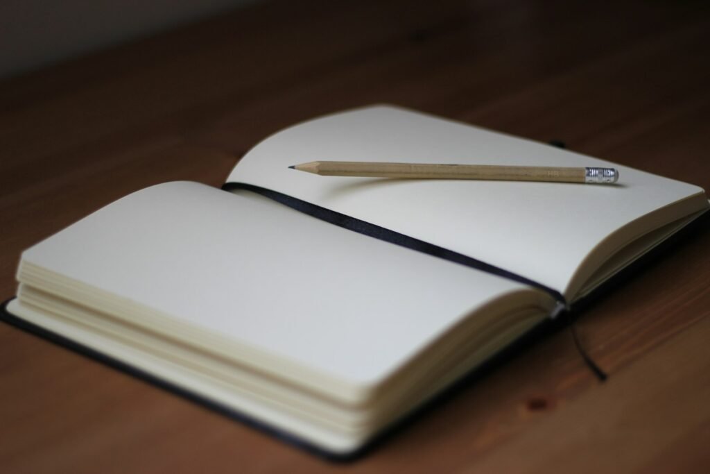 Pencil resting on an open notebook page, ready for a survivor to write down dates and names