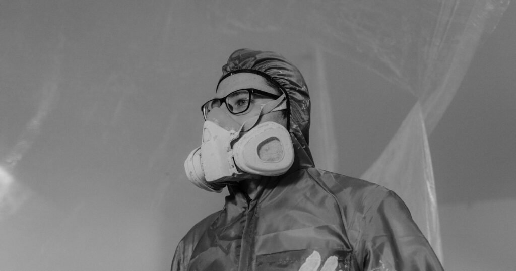 Worker in a respirator and protective gear, as used around asbestos