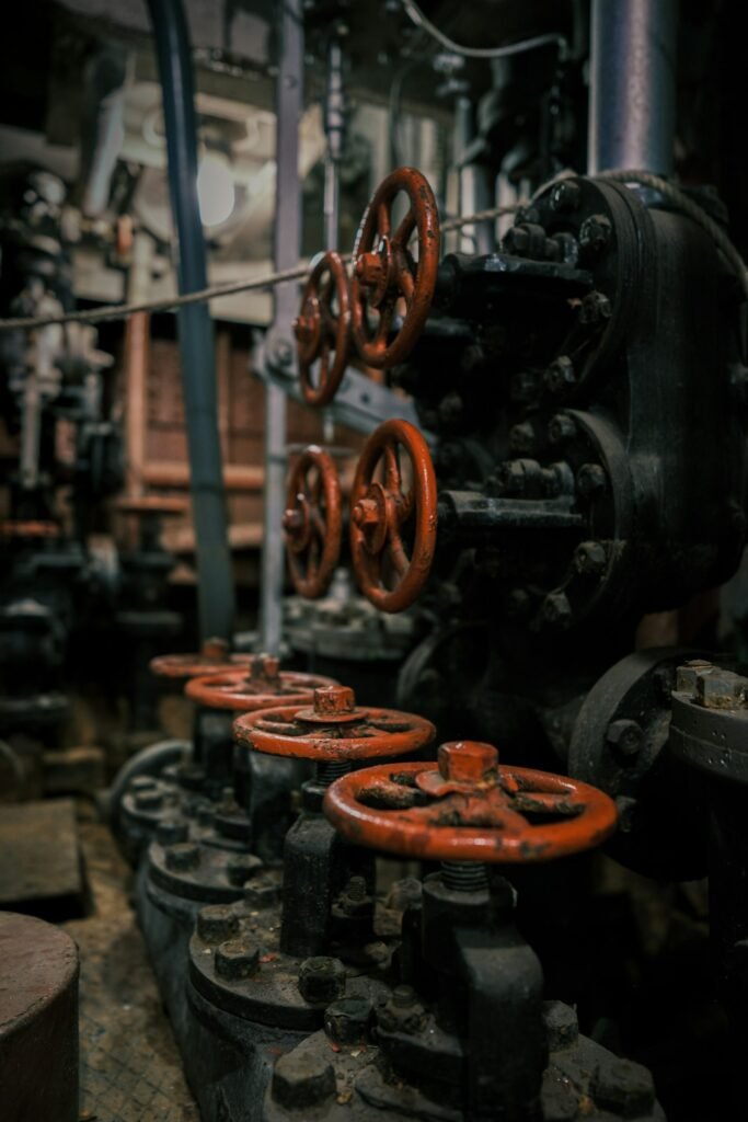 Row of old industrial valves and pipes, the kind of worksite linked to mesothelioma lawsuit settlements