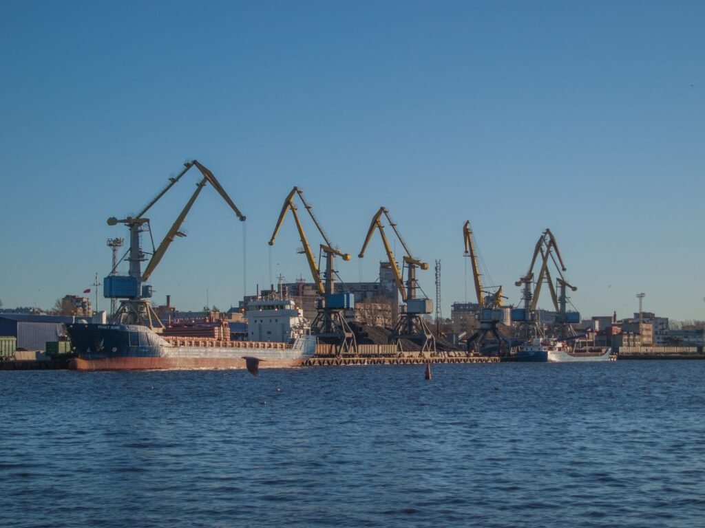 Industrial shipyard with cranes and ships under construction on a sunny day