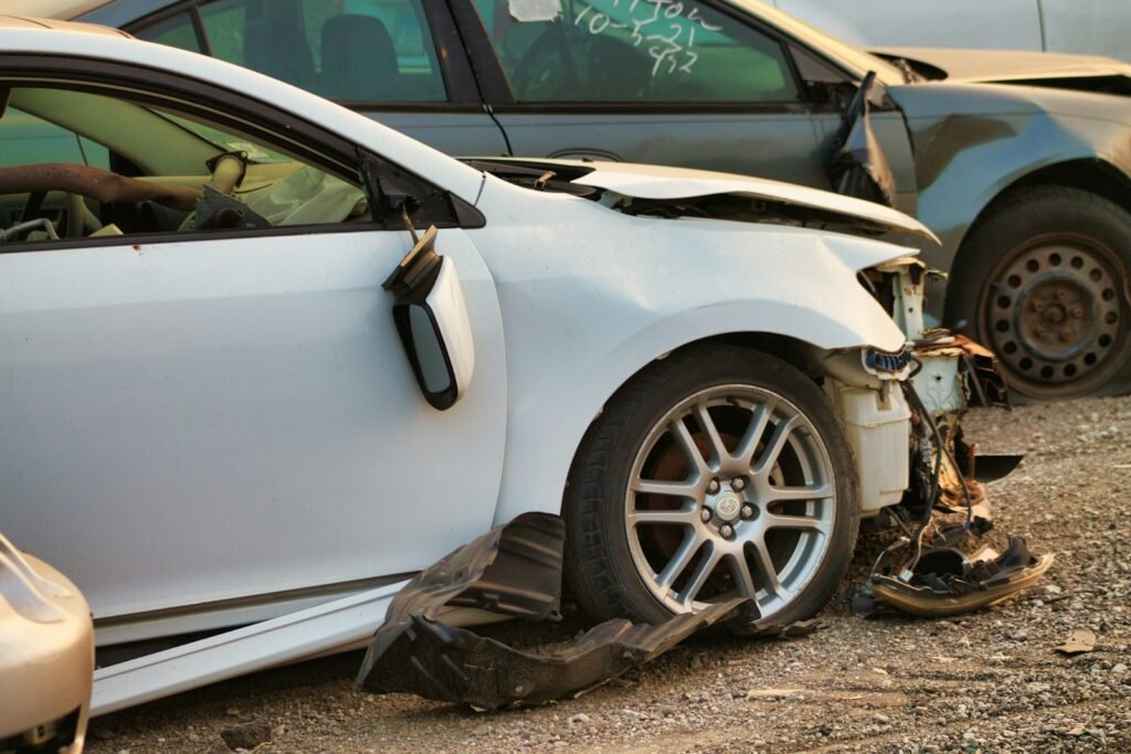 Damaged gray car on a city street after a collision, the kind of scene behind many car crash lawsuits