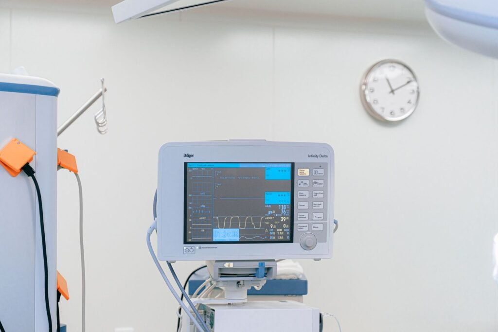 Heart rate monitor displaying vital signs in a hospital room