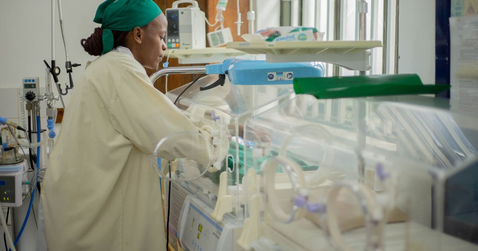 Nurse caring for a newborn in a neonatal intensive care unit, illustrating NEC medical records