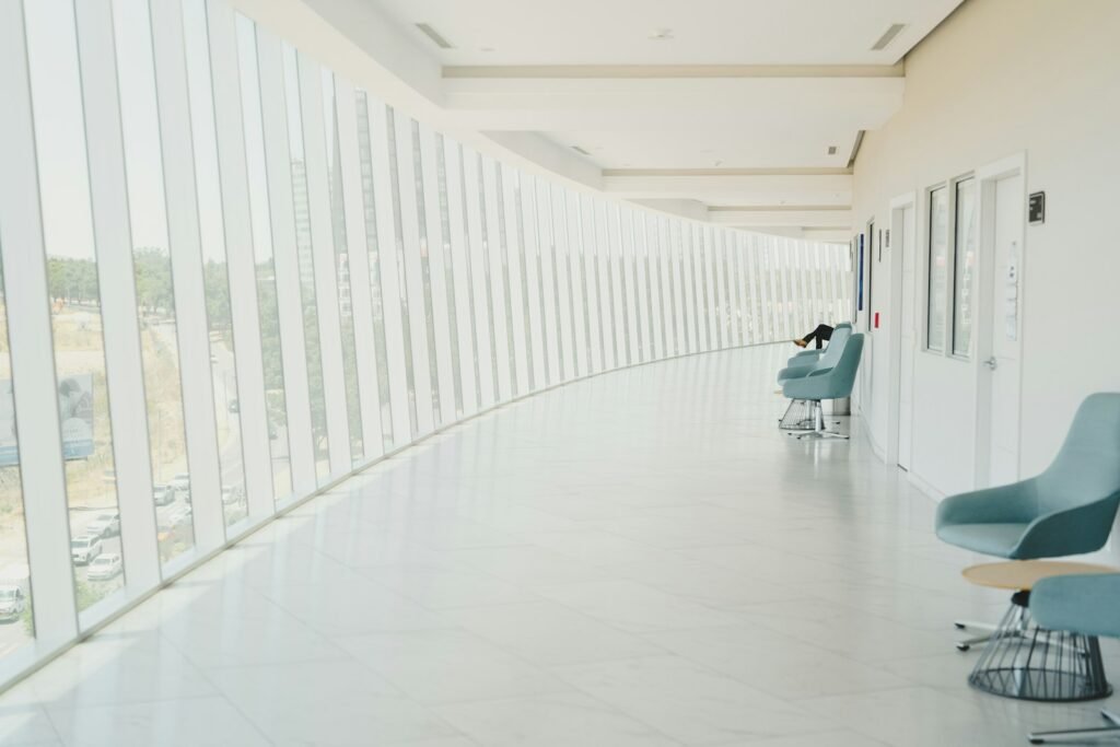 Long hospital hallway with a row of chairs, like the waiting areas patients used before the Northwell sleep center lawsuit