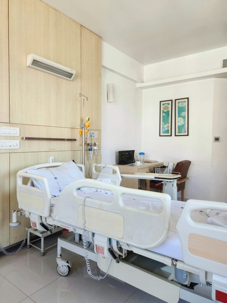 Empty hospital room with two beds and a desk, showing a quiet overnight patient space