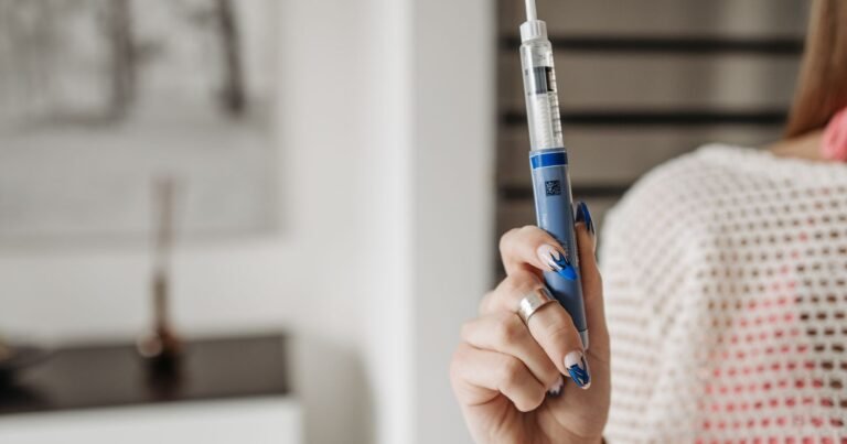 Woman holding a GLP-1 injection pen, illustrating Ozempic lawsuit eligibility