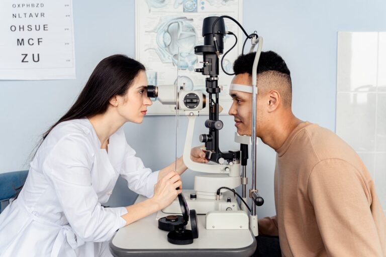 Optometrist examining a patient's eyes with a slit lamp, the kind of exam used to diagnose NAION vision loss
