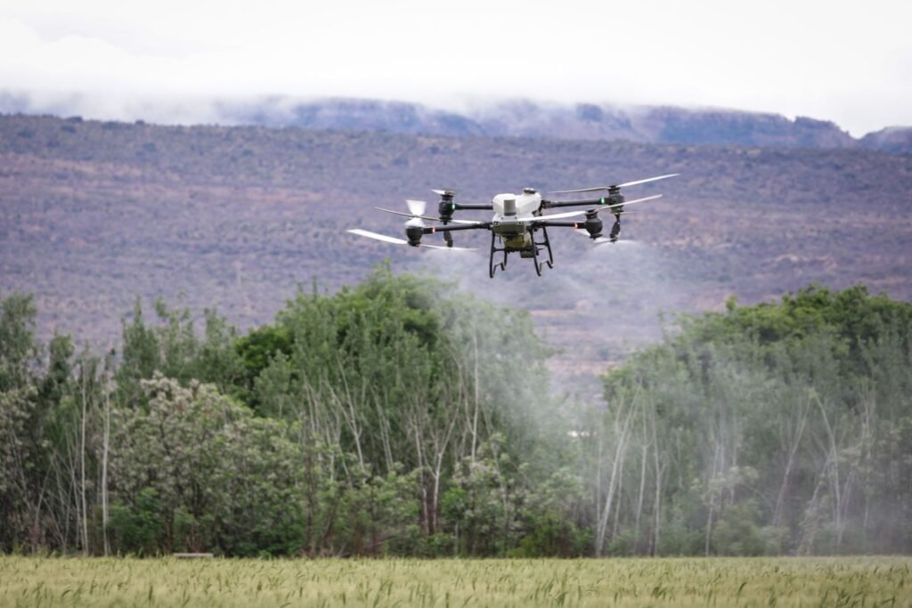 Agricultural drone spraying over farmland, a possible source of pesticide drift exposure for nearby homes