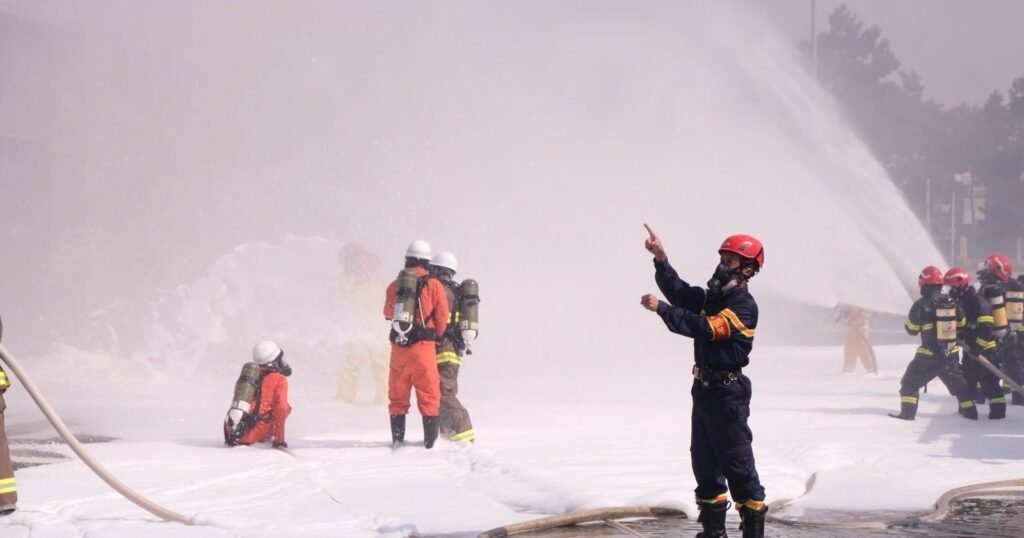 Firefighters spraying AFFF firefighting foam during a training exercise