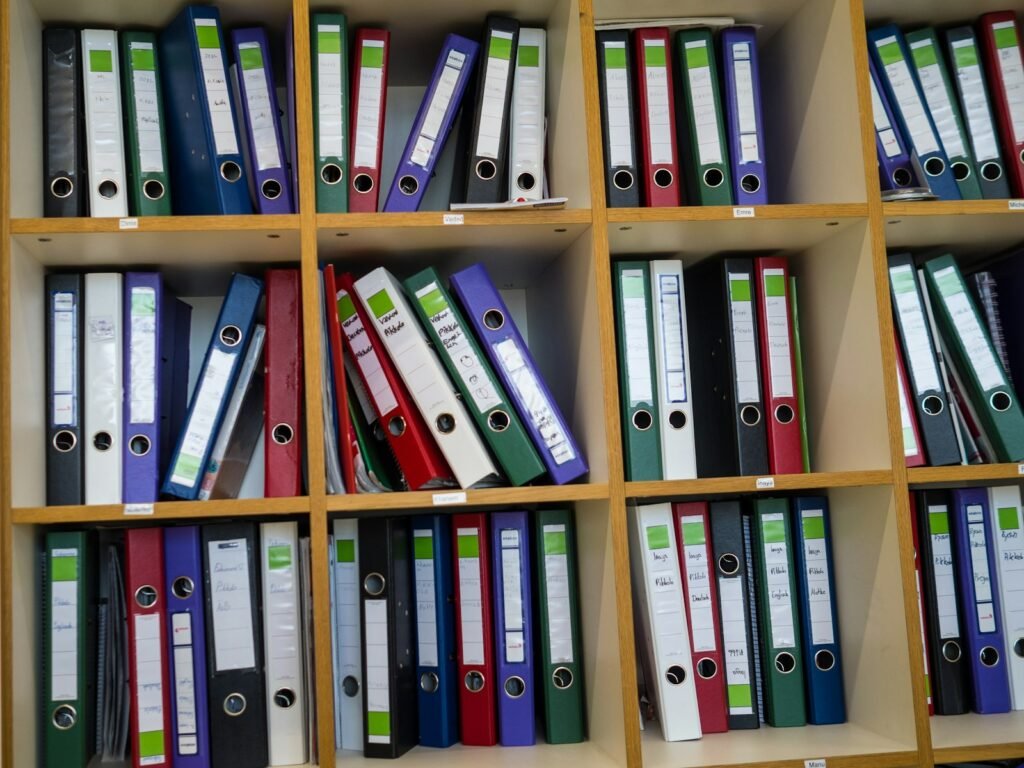 Shelves filled with blue binders and storage boxes in an office