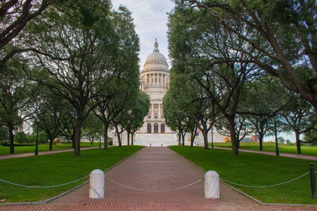 Rhode Island State House in Providence among green trees, where the Rhode Island revival window law was passed