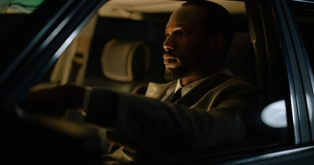 Rideshare driver at the wheel at night