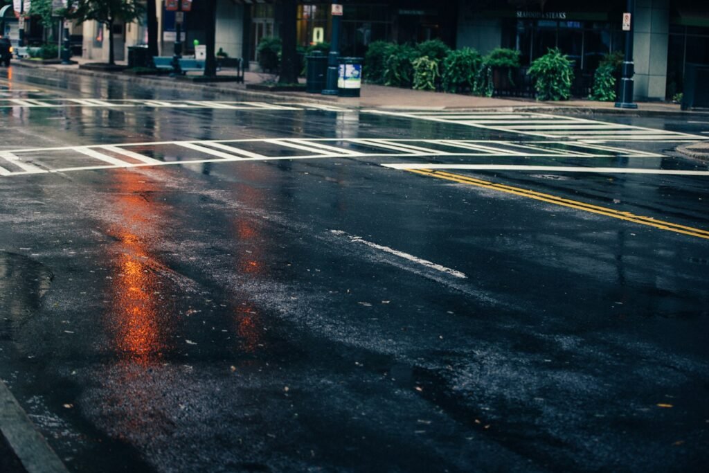 Empty wet city road at dusk, a quiet scene for survivors weighing a rideshare assault lawsuit