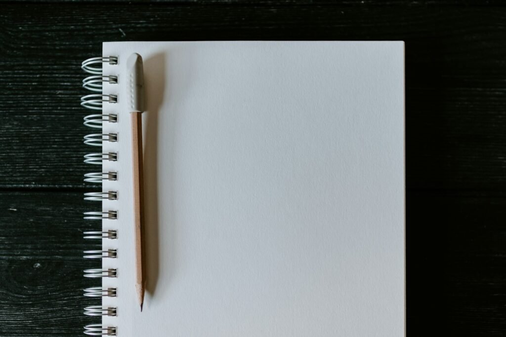 Pencil on a blank spiral notebook, ready for notes about Roblox claims and filing deadlines