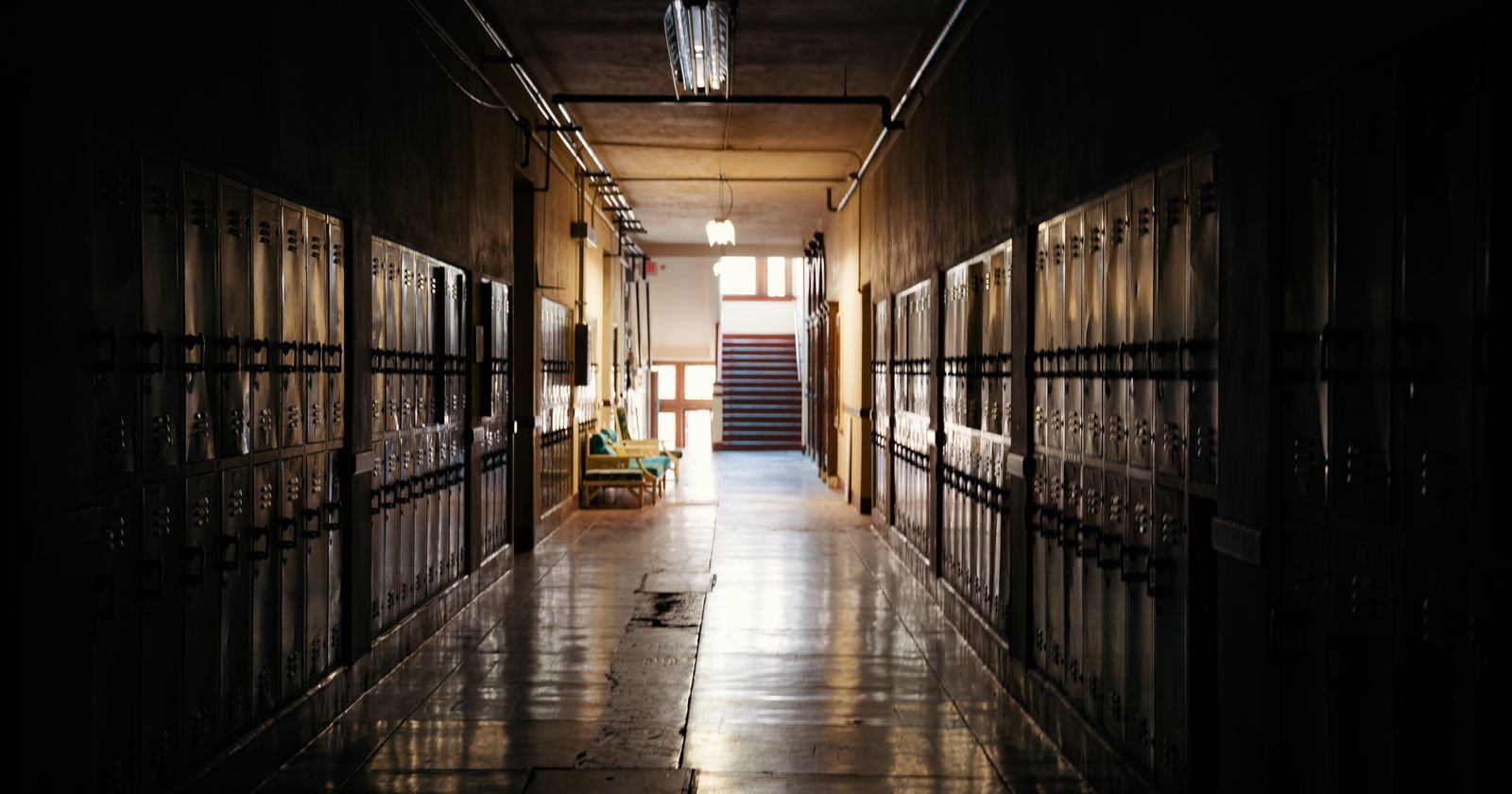 Empty school hallway with lockers, illustrating evidence in California school abuse lawsuits