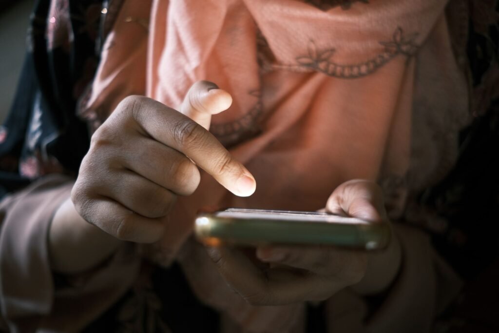 Social media addiction lawsuit eligibility: close-up of a finger scrolling a social media feed on a smartphone
