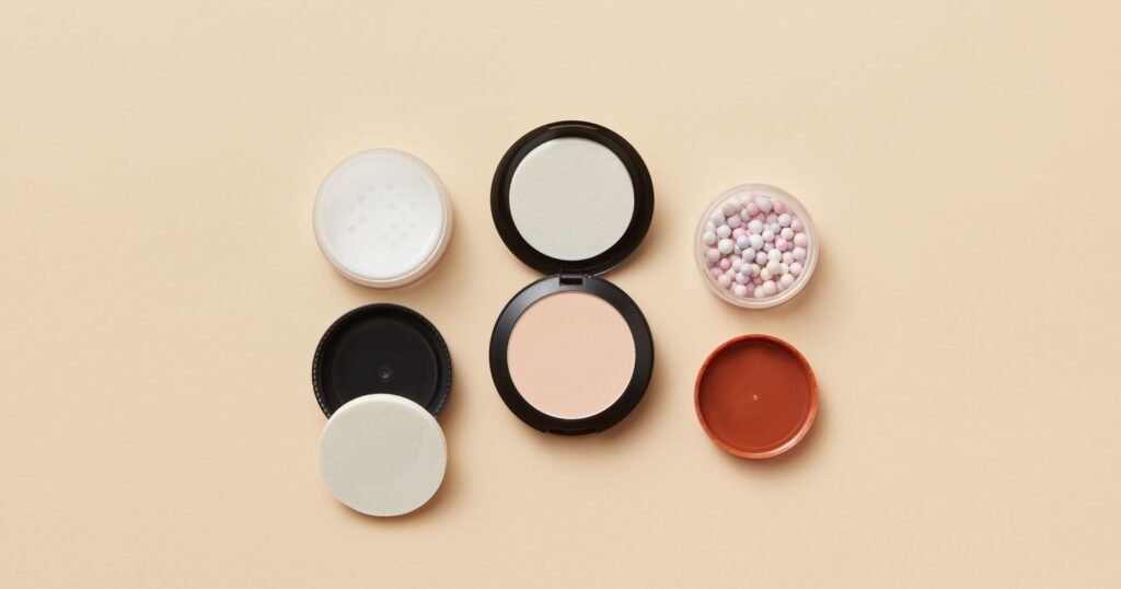 Powder compacts and cosmetic powders on a table